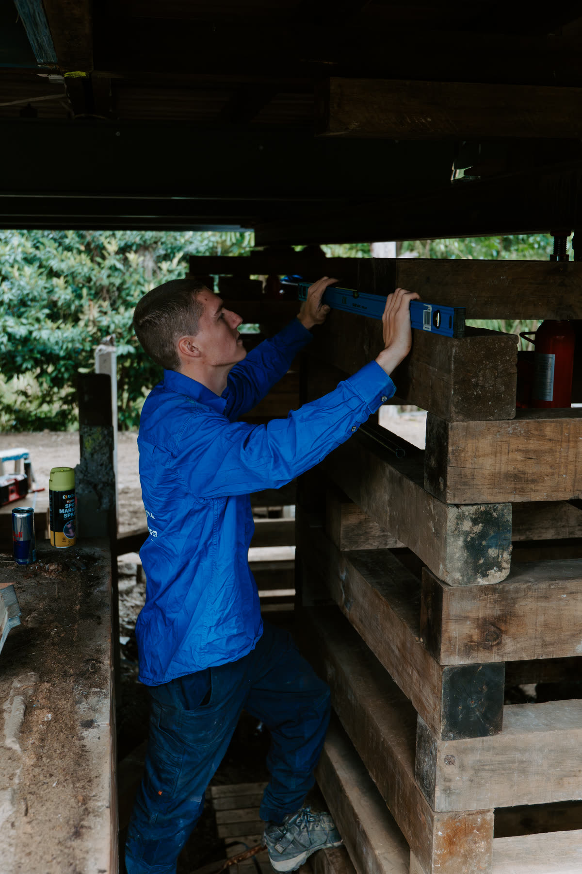 Videographer filming a tradie on site
