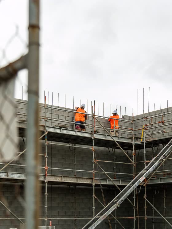 Crew working on a scaffolded building site