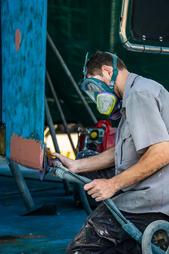Tradesman in a respirator spray painting
