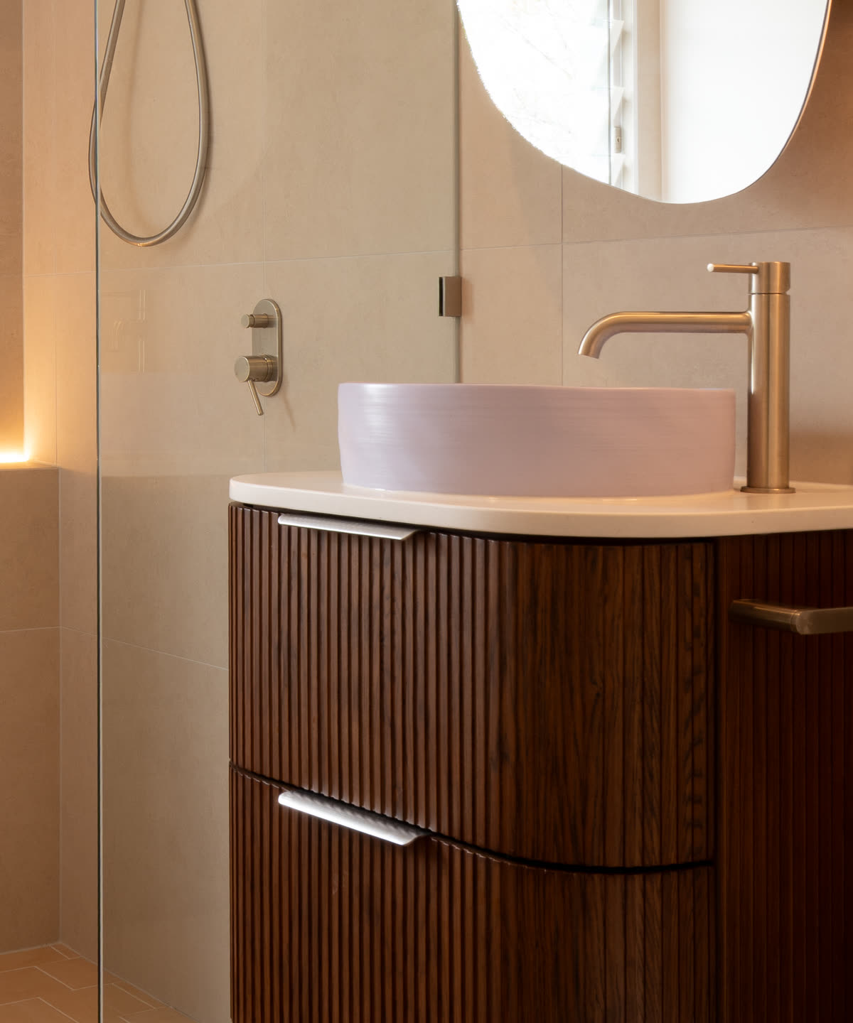 Basin and fluted timber vanity in a bathroom by Muston Building Services